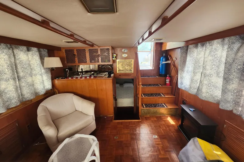 Slide: The Image of Interior of a 1988 Marine Trader 43 yacht with cozy seating and wooden decor. - 5