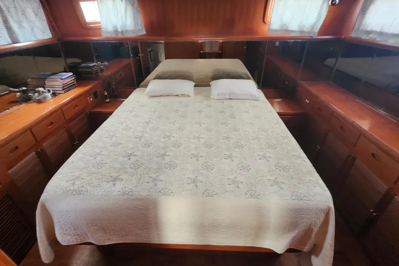 Slide: The Image of Luxurious cabin interior of 1988 Marine Trader 43 yacht with cozy bed and wooden furnishings. - 6