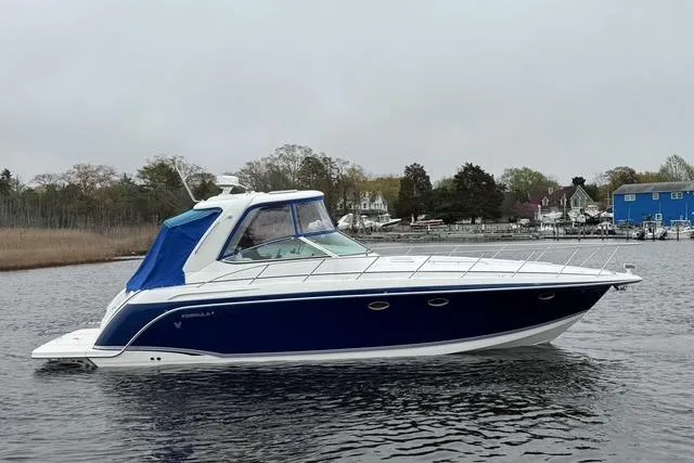 Slide: The Image of 2006 Formula 40 Performance Cruiser on calm water, featuring sleek blue and white design. - 10