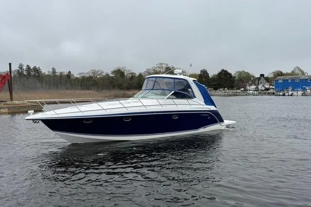 Slide: The Image of 2006 Formula 40 Performance Cruiser on calm water, featuring sleek blue and white design. - 12