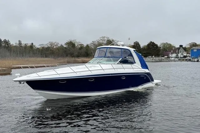 Slide: The Image of 2006 Formula 40 Performance Cruiser on calm water, showcasing sleek design and blue hull. - 13