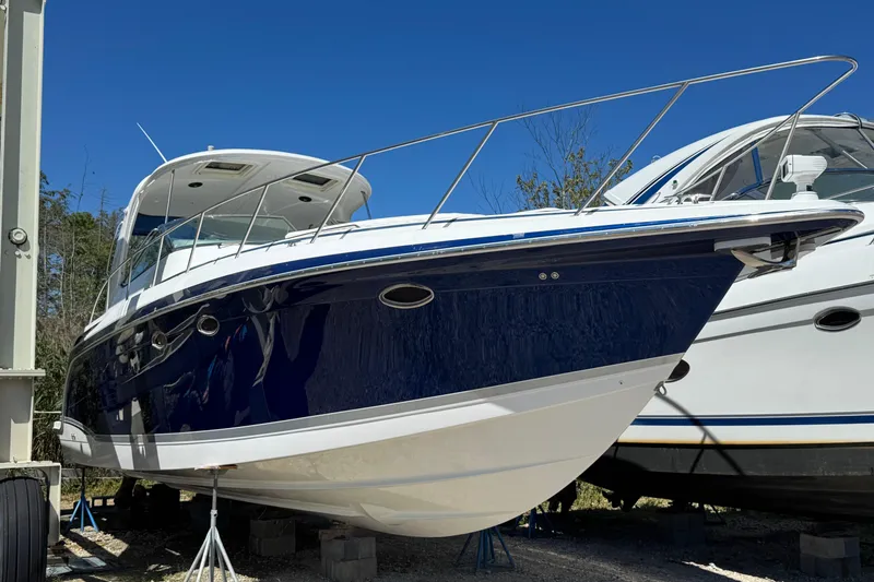 Slide: The Image of 2006 Formula 40 Performance Cruiser boat on stands, blue hull, sunny day. - 15
