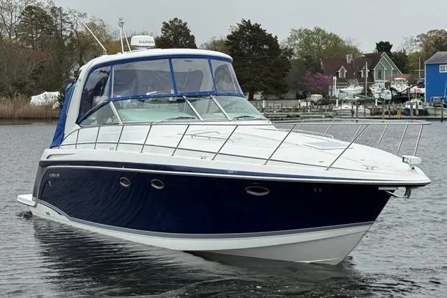 Slide: The Image of 2006 Formula 40 Performance Cruiser on calm water, showcasing sleek design and blue hull. - 2