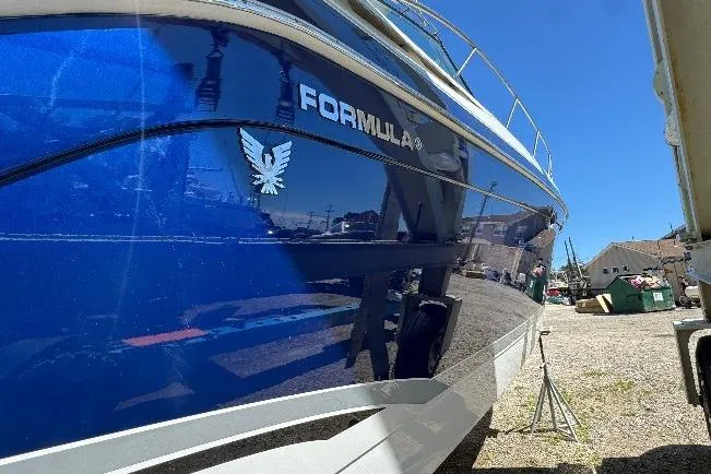 Slide: The Image of 2006 Formula 40 Performance Cruiser with blue hull, docked outdoors. - 23