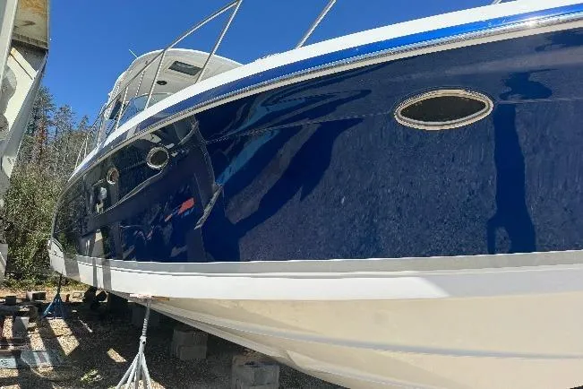 Slide: The Image of 2006 Formula 40 Performance Cruiser with sleek blue hull, docked outdoors. - 24