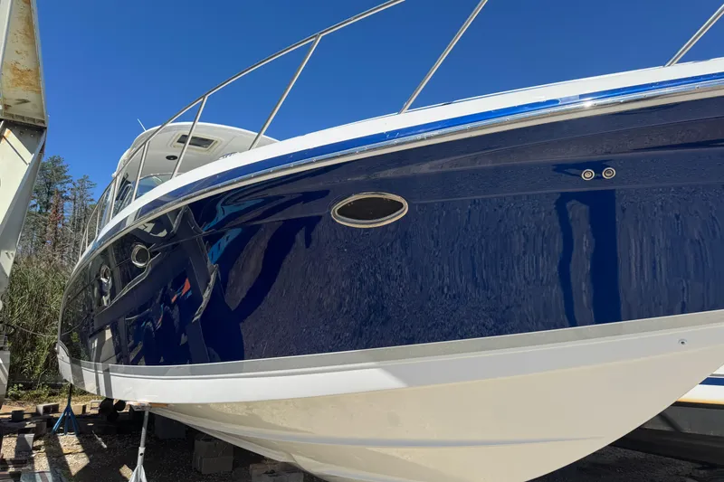 Slide: The Image of 2006 Formula 40 Performance Cruiser with sleek blue hull, docked under clear sky. - 27