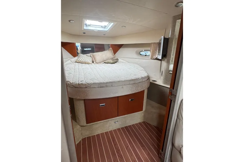 Slide: The Image of Interior cabin of a 2006 Formula 40 Performance Cruiser with a cozy bed and wooden accents. - 31