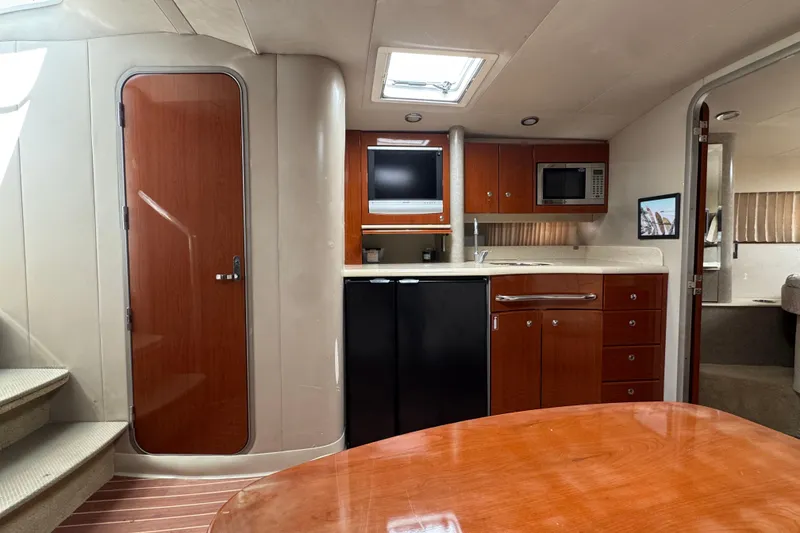 Slide: The Image of Interior of a 2006 Formula 40 Performance Cruiser with kitchenette and wood cabinetry. - 33