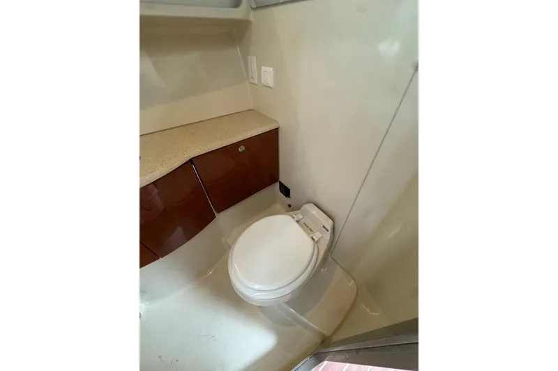 Slide: The Image of 2006 Formula 40 Performance Cruiser bathroom with modern fixtures and wooden cabinetry. - 41