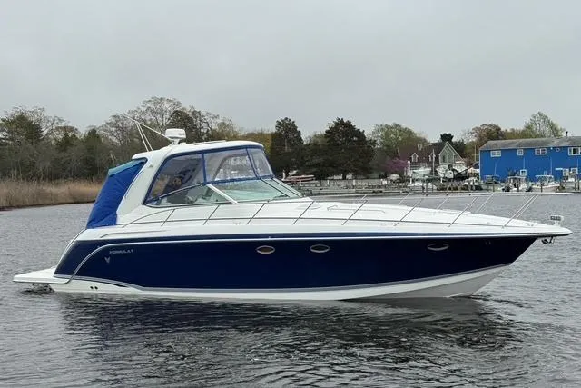 Slide: The Image of 2006 Formula 40 Performance Cruiser on calm water, featuring sleek design and blue accents. - 5