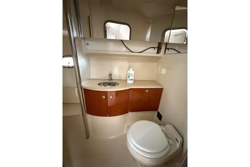 Slide: The Image of 2006 Formula 40 Performance Cruiser bathroom with sink, toilet, and storage cabinets. - 52