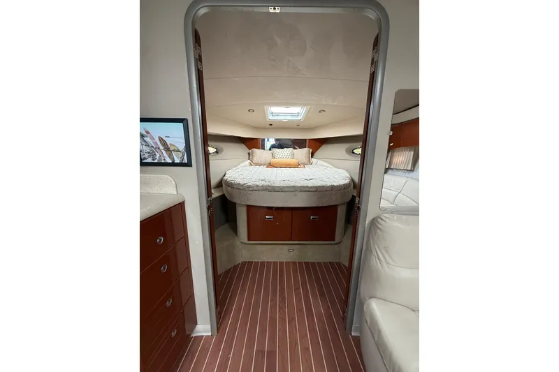 Slide: The Image of Luxurious interior of a 2006 Formula 40 Performance Cruiser with cozy bed and elegant wood finish. - 61