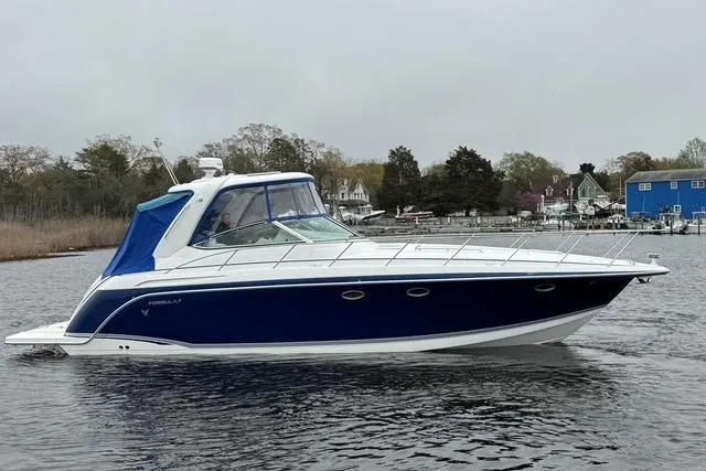 Slide: The Image of 2006 Formula 40 Performance Cruiser on calm water, featuring sleek blue and white design. - 7