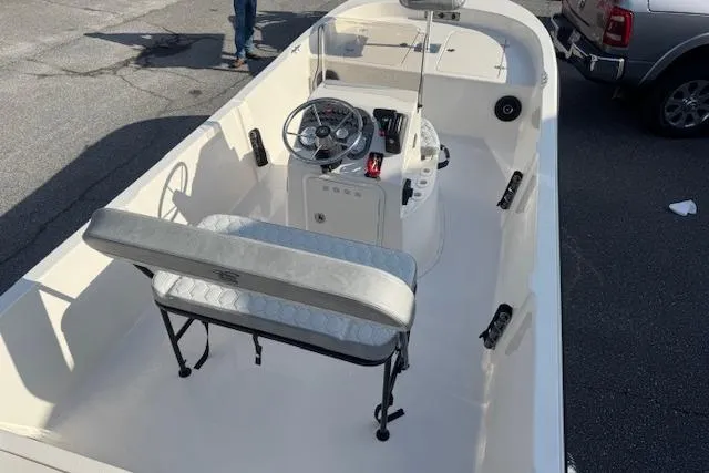 Slide: The Image of 2026 Carolina Skiff 192 JLS boat with center console and seating, parked outdoors. - 10
