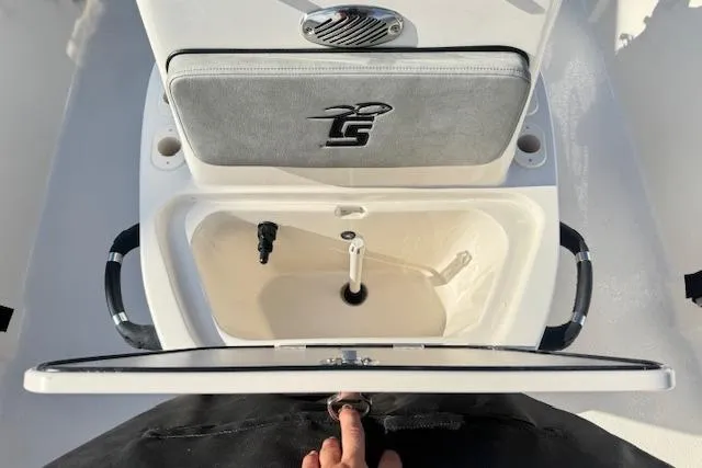 Slide: The Image of 2026 Carolina Skiff 192 JLS boat interior with open storage compartment and handle. - 14
