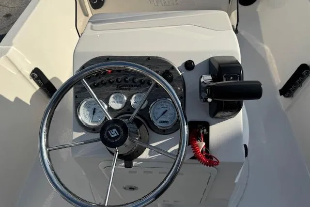 Slide: The Image of Steering console of 2026 Carolina Skiff 192 JLS boat with gauges and controls. - 17
