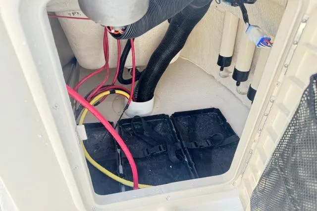 Slide: The Image of Battery compartment of 2026 Carolina Skiff 192 JLS with wiring and hoses visible. - 21