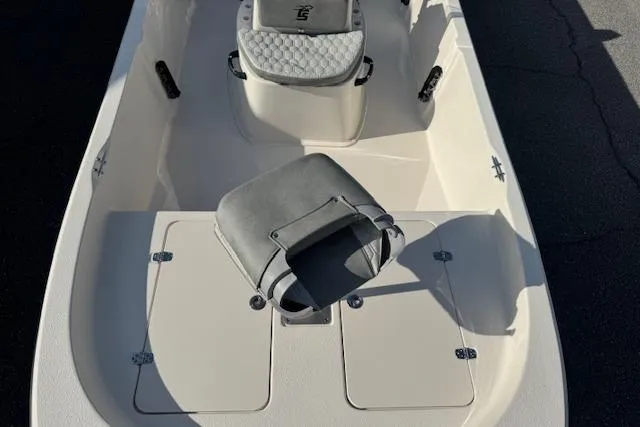 Slide: The Image of 2026 Carolina Skiff 192 JLS boat interior with seating and storage compartments. - 7