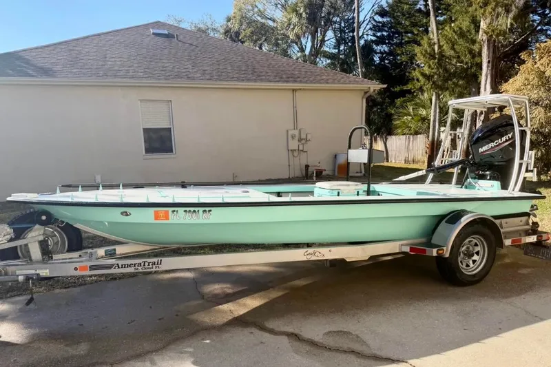 Slide: The Image of 2017 Cayo Boatworks 173 on trailer, parked near a house, featuring a Mercury outboard motor. - 5