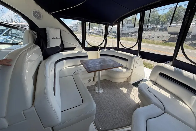Slide: The Image of Interior of 2007 Sea Ray 380 Sundancer yacht with plush seating and wooden table. - 11
