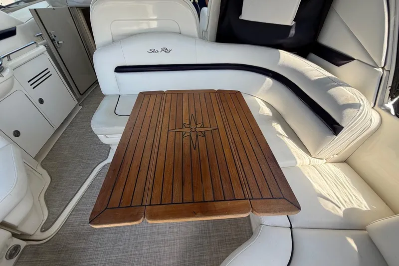 Slide: The Image of Luxurious interior of 2007 Sea Ray 380 Sundancer with elegant wooden table and seating. - 12