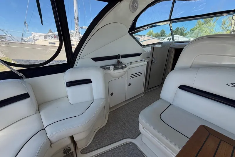 Slide: The Image of Interior of 2007 Sea Ray 380 Sundancer yacht with white seating and kitchenette. - 13