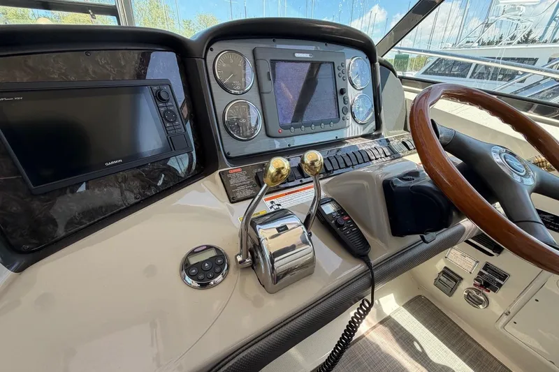 Slide: The Image of Helm of 2007 Sea Ray 380 Sundancer with navigation equipment and wooden steering wheel. - 15