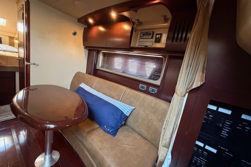 Slide: The Image of Luxurious interior of 2007 Sea Ray 380 Sundancer with elegant seating and wooden finishes. - 21