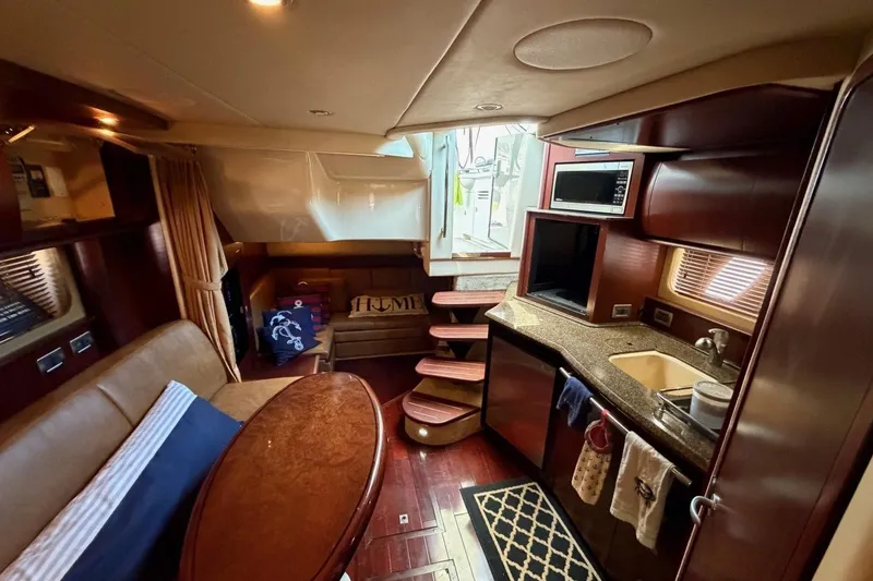 Slide: The Image of Luxurious interior of 2007 Sea Ray 380 Sundancer yacht with kitchen and seating area. - 22