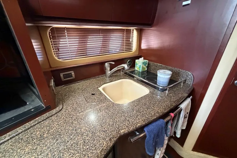 Slide: The Image of Luxurious 2007 Sea Ray 380 Sundancer yacht kitchen with granite countertop and modern amenities. - 23