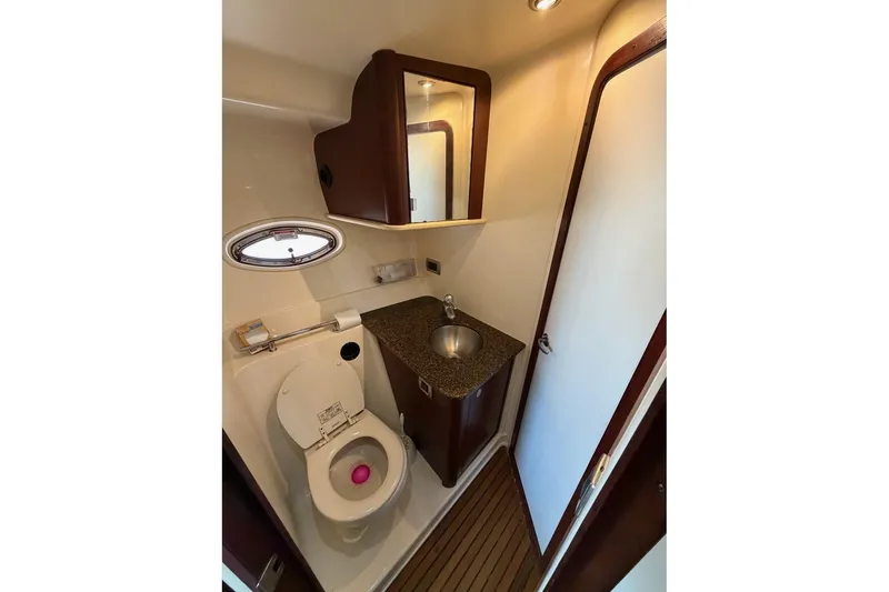 Slide: The Image of Compact bathroom in 2007 Sea Ray 380 Sundancer yacht with sink and toilet. - 24