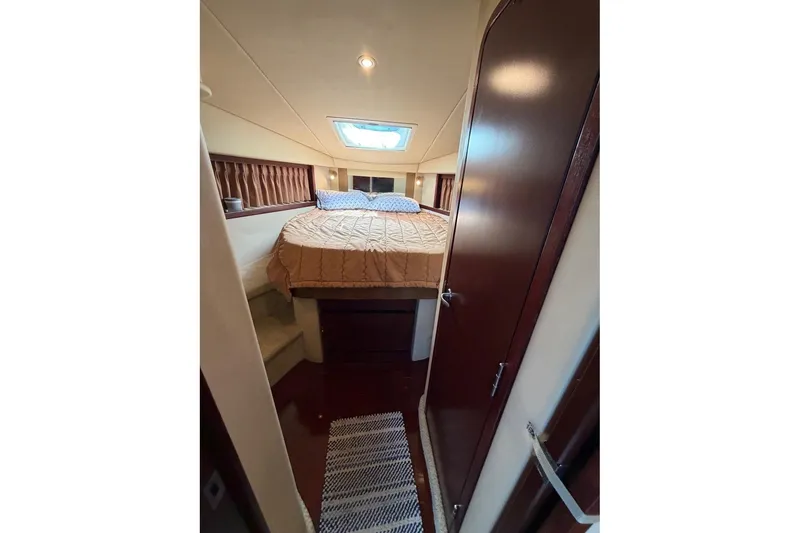 Slide: The Image of Cabin interior of 2007 Sea Ray 380 Sundancer with bed and skylight. - 25