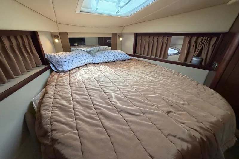 Slide: The Image of Luxurious cabin interior of 2007 Sea Ray 380 Sundancer with cozy bed and skylight. - 26