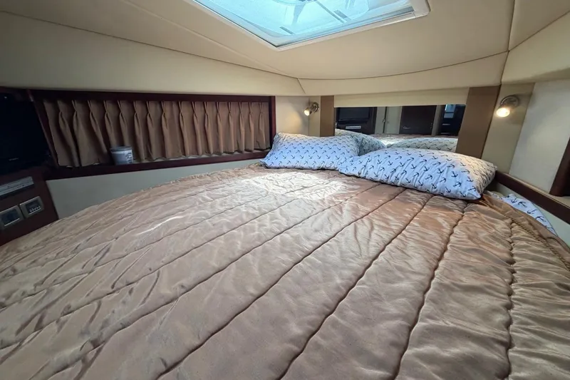 Slide: The Image of Luxurious cabin interior of 2007 Sea Ray 380 Sundancer with cozy bedding and ambient lighting. - 27
