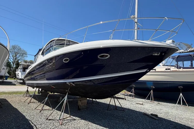 Slide: The Image of 2007 Sea Ray 380 Sundancer yacht on stands, blue hull, sunny day. - 3