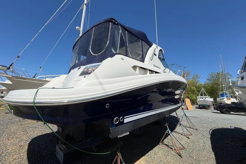 Slide: The Image of 2007 Sea Ray 380 Sundancer boat on stands in a marina under clear blue sky. - 4