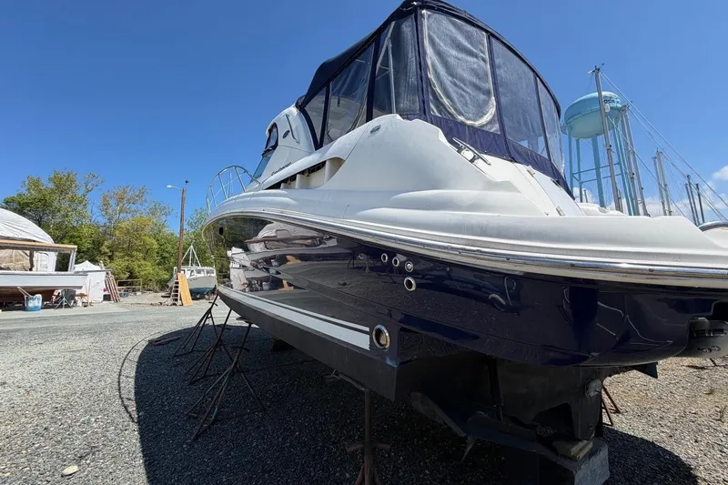 Slide: The Image of 2007 Sea Ray 380 Sundancer yacht on stands, blue hull, outdoor storage area. - 5