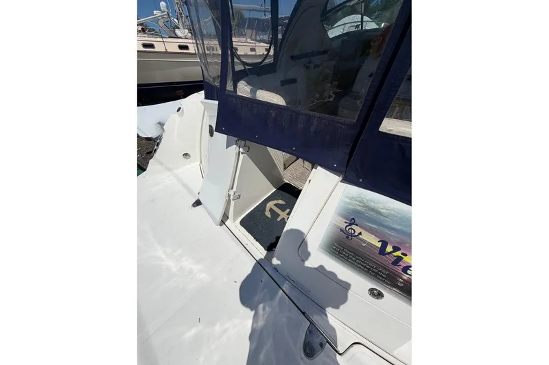 Slide: The Image of 2007 Sea Ray 380 Sundancer boat deck with blue canopy and open door. - 7