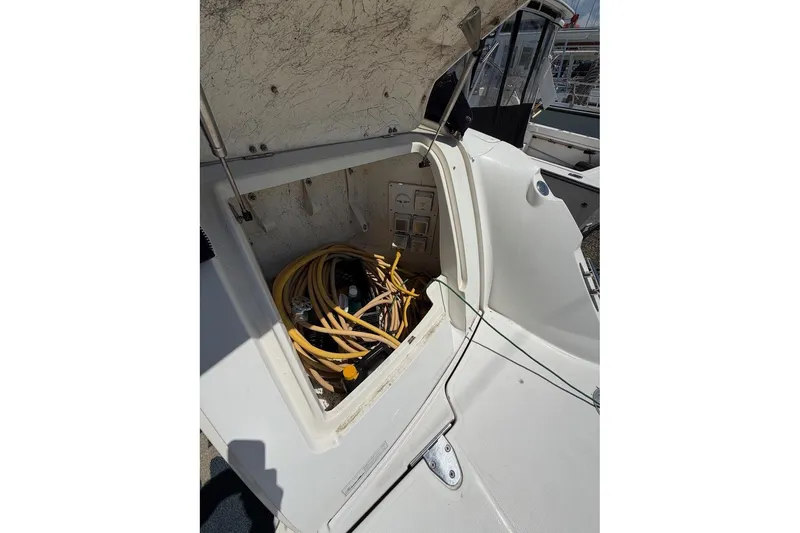 Slide: The Image of Open storage compartment on 2007 Sea Ray 380 Sundancer boat with cables inside. - 8