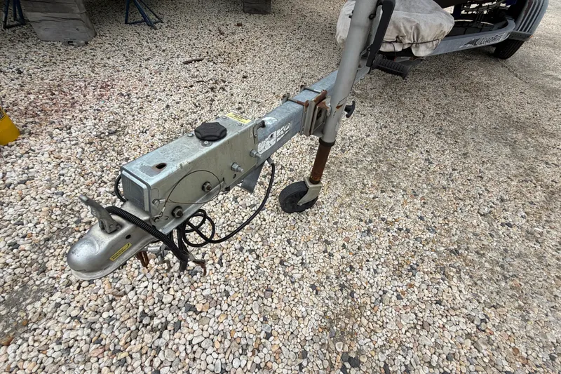 Slide: The Image of Trailer hitch of a 2003 Parker 21SE Center Console on gravel surface. - 10