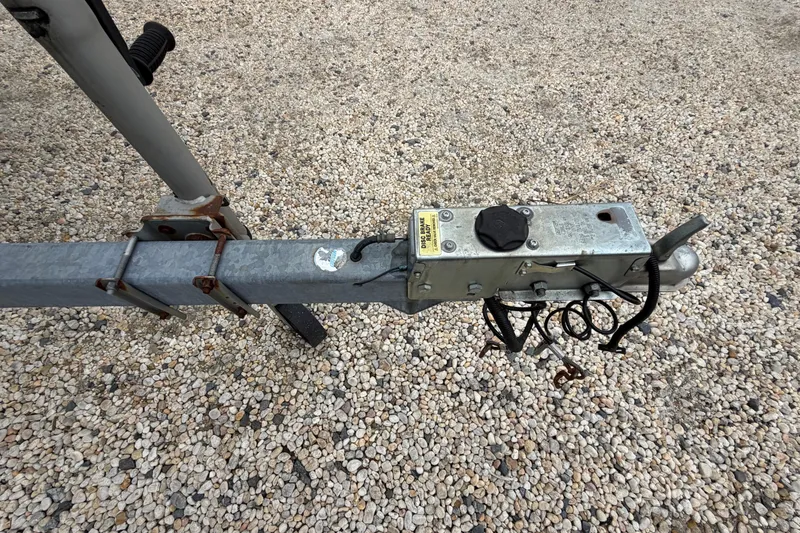 Slide: The Image of Trailer hitch of a 2003 Parker 21SE Center Console on gravel surface. - 11
