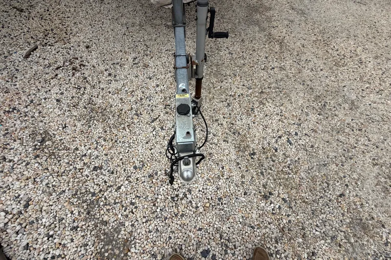Slide: The Image of Trailer hitch of a 2003 Parker 21SE Center Console on gravel surface. - 12