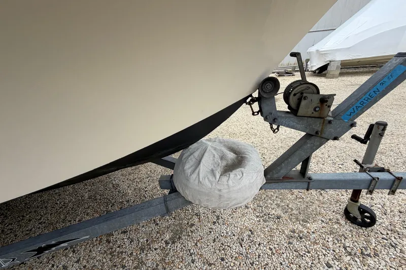 Slide: The Image of 2003 Parker 21SE Center Console boat on trailer, gravel ground, close-up view. - 13