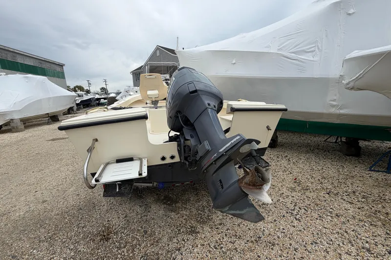 Slide: The Image of 2003 Parker 21SE Center Console boat with outboard motor in storage yard. - 18