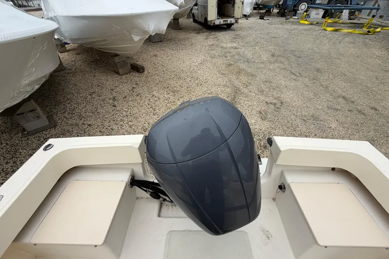 Slide: The Image of 2003 Parker 21SE Center Console boat with outboard motor in storage yard. - 20