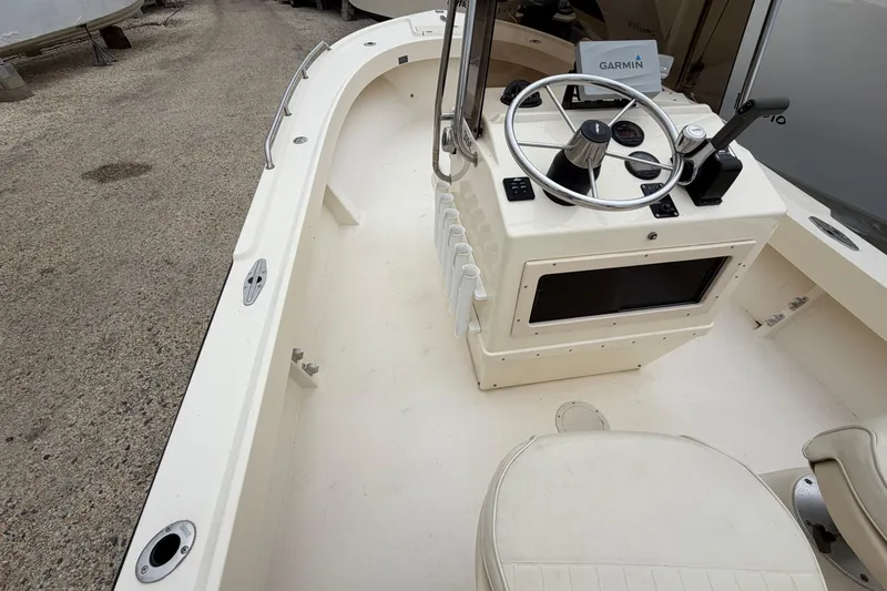 Slide: The Image of 2003 Parker 21SE Center Console boat interior with steering wheel and Garmin navigation system. - 28