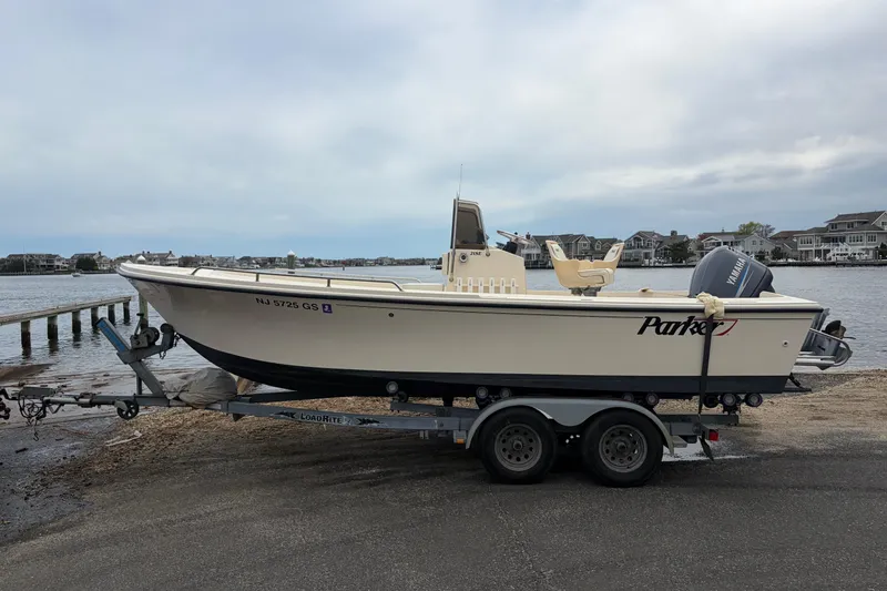 Slide: The Image of 2003 Parker 21SE Center Console boat on trailer by waterfront homes. - 3