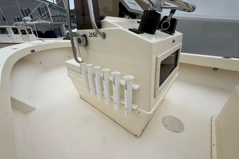 Slide: The Image of 2003 Parker 21SE Center Console boat interior with rod holders and steering wheel. - 32