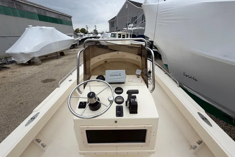 Slide: The Image of 2003 Parker 21SE Center Console boat with Garmin navigation, docked and covered. - 33