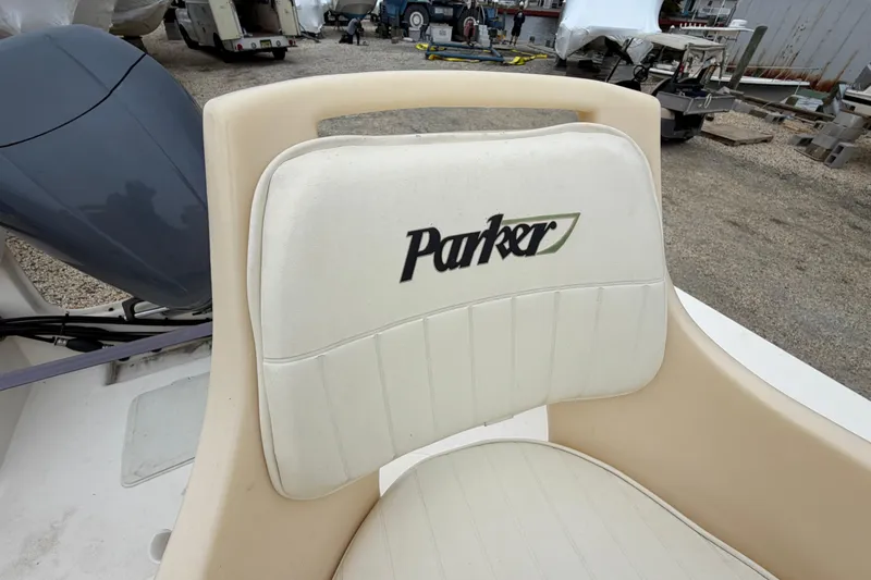 Slide: The Image of 2003 Parker 21SE Center Console boat seat with logo in a marina setting. - 39